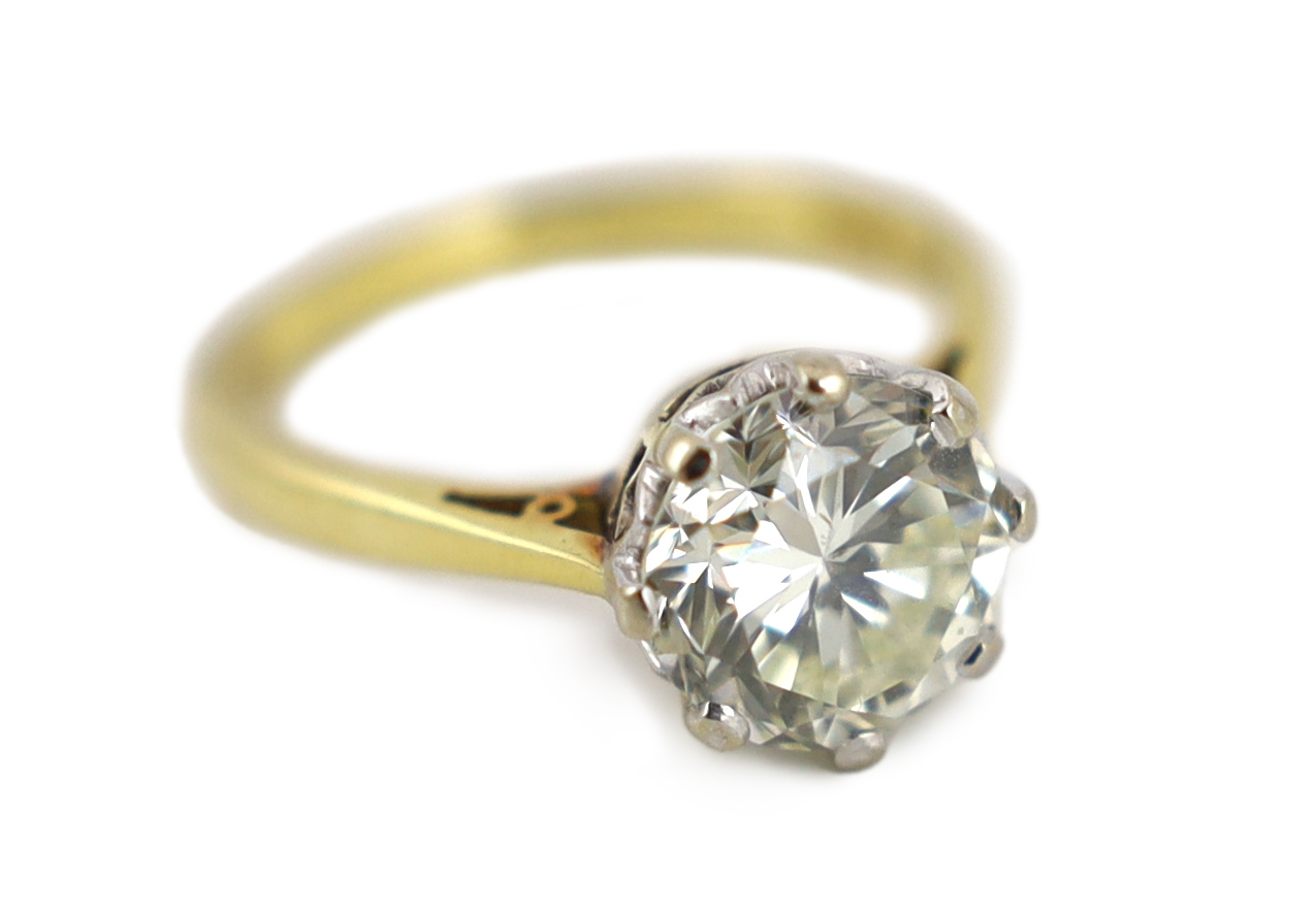 A modern 18ct gold and solitaire diamond set ring